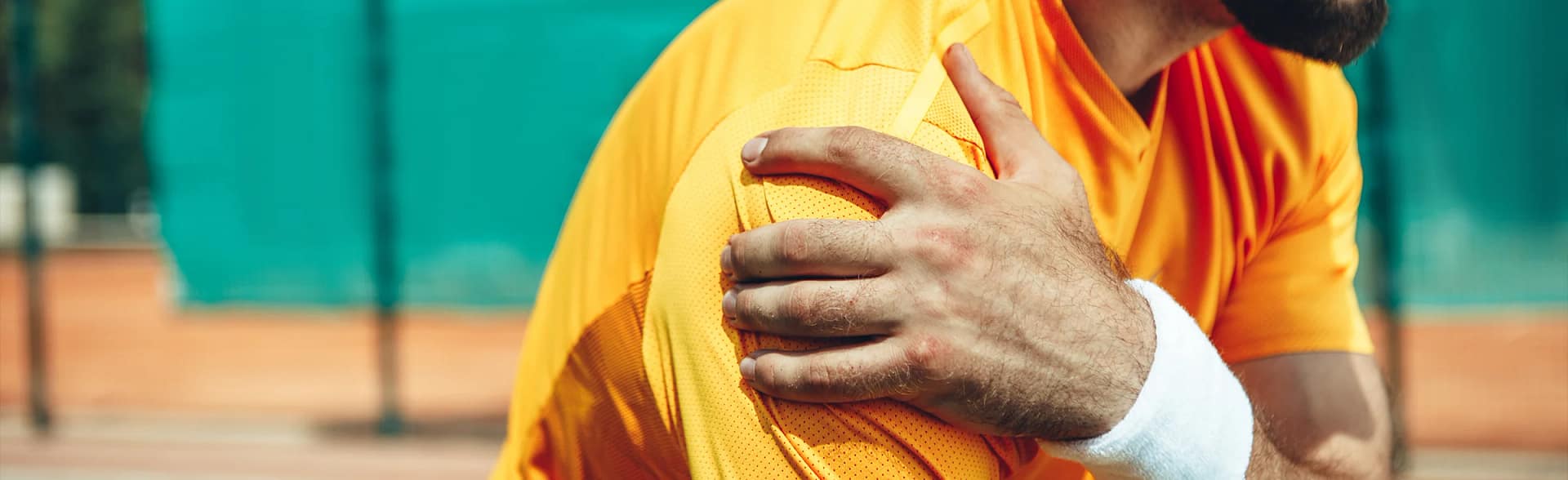 Man holdinh shoulder after receiving a shoulder sporting injury
